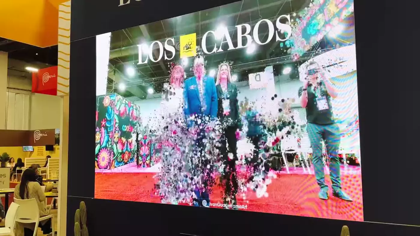 The LED wall dissolving the opening delegation into particle swirls in real time
